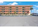Low angle view of exterior of the condo complex and parking area at 19701 Gulf Blvd # 231, Indian Shores, FL 33785