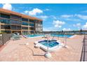 Relaxing pool and hot tub area with lounge chairs for residents at 19701 Gulf Blvd # 231, Indian Shores, FL 33785