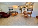 An open-concept living room with a tiled floor, comfortable seating, and adjacent dining area at 2370 Jamaican St # 46, Clearwater, FL 33763