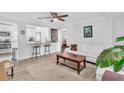 Bright living room featuring a ceiling fan, hardwood floors, and an opening to the kitchen at 2460 16Th N Ave, St Petersburg, FL 33713