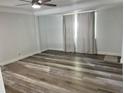 Bright living room with wood-look flooring, neutral walls, and a ceiling fan for added comfort at 2460 16Th N Ave, St Petersburg, FL 33713
