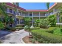A lovely courtyard with lush landscaping, a water feature, and benches for residents' enjoyment at 2700 Bayshore Blvd # 4204, Dunedin, FL 34698