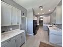 Bright kitchen featuring stainless steel appliances and light gray cabinets at 29123 Crossland Dr, Wesley Chapel, FL 33543