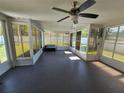 Bright sunroom features large windows providing ample natural light and tiled floors at 29123 Crossland Dr, Wesley Chapel, FL 33543