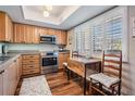 Charming kitchen featuring wood cabinets, stainless appliances, and plantation shutters at 3076 Eastland Blvd # 305, Clearwater, FL 33761