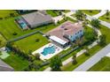 Aerial view of a home with a large backyard, pool, patio, and basketball court at 3226 Cordoba Ranch Blvd, Lutz, FL 33559