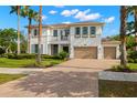 A charming two-story home with a brick paver driveway, an attached two-car garage, and tropical landscaping at 3226 Cordoba Ranch Blvd, Lutz, FL 33559