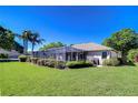 Expansive backyard showcasing a screened-in lanai, lush landscaping, and a well-maintained lawn at 4904 Breyer Wood Ct, Valrico, FL 33596