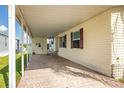 Covered carport area featuring ample space, views to the side yard, and access to the home's side entrance at 8632 Fantasia Park Way, Riverview, FL 33578