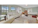 Bright and airy living space featuring large windows and comfortable seating at 110 E Saint Lucia Loop, Apollo Beach, FL 33572