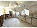 Open dining area with large windows and tile flooring, in need of renovation at 121 175Th E Ave, Redington Shores, FL 33708