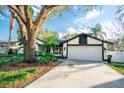 Charming single-story home with well-maintained lawn and a two-car garage at 12335 Yellow Rose Cir, Riverview, FL 33569