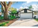 Charming single-story home with well-maintained lawn and a two-car garage at 12335 Yellow Rose Cir, Riverview, FL 33569