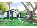 Charming single-story home with manicured front yard and inviting landscaping at 12335 Yellow Rose Cir, Riverview, FL 33569
