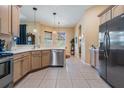 Bright kitchen featuring tile floors, stainless steel appliances, and ample counter space at 13514 Thoroughbred Dr, Dade City, FL 33525