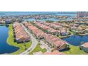 Community aerial view of waterfront homes with red tile roofs and lush landscaping on a sunny day at 16 Franklin S Ct # A, St Petersburg, FL 33711