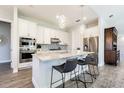 Modern kitchen with white cabinets, stainless steel appliances, and a spacious center island at 16 Franklin S Ct # A, St Petersburg, FL 33711