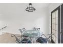 Cozy dining area featuring modern lighting and a glass-top table with seating for four at 170 E Davis Blvd, Tampa, FL 33606