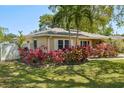 Charming single-story home featuring lush landscaping and beautiful foliage at 1808 Gray S St, Gulfport, FL 33707