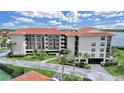 Condo building featuring multi-story living, tropical landscaping and beautiful waterfront views at 1810 Mariner Dr # 207, Tarpon Springs, FL 34689