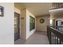 Well-lit hallway with unit number, neutral paint and an exit sign at 1810 Mariner Dr # 207, Tarpon Springs, FL 34689