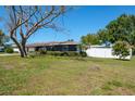 View of the home showcasing the well-kept lawn and the privacy fence at 1828 Stancel Dr, Clearwater, FL 33764