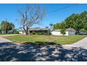 Home on a corner lot featuring a mature tree in the front yard at 1828 Stancel Dr, Clearwater, FL 33764