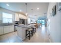 Bright kitchen features granite counters, stainless appliances, and a breakfast bar with pendant lighting at 19212 Iron Topsail Isle, Land O Lakes, FL 34638