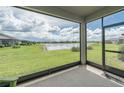 Screened lanai offering beautiful view of backyard, lake, and community at 19212 Iron Topsail Isle, Land O Lakes, FL 34638