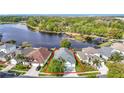 Stunning aerial view of a lakeside home with lush landscaping and a private dock at 2327 Shirecrest Cove Way, Lutz, FL 33558