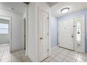 Welcoming entryway featuring tiled floors, neutral wall color, and a solid front door with sidelight at 2329 Towering Oaks Cir, Seffner, FL 33584