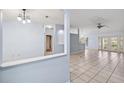 Open-concept living area featuring tile flooring and a seamless transition to other rooms at 2329 Towering Oaks Cir, Seffner, FL 33584