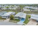 Aerial view of community with houses, landscaping, and water feature running between houses at 36328 Bonney Dr, Zephyrhills, FL 33541