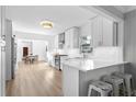 Modern kitchen featuring white cabinetry, stainless steel appliances, and a breakfast bar at 4506 W Beachway Dr, Tampa, FL 33609