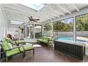 Bright sunroom with skylights, comfortable seating, and a view of the pool at 4506 W Beachway Dr, Tampa, FL 33609