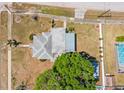 An aerial view of a home with fenced yard, detached garage, and mature tree at 501 61St Ne Ave, St Petersburg, FL 33703