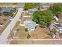 Aerial view of a single-story home with a fenced yard, a partial pool, and a green tree in the back yard at 501 61St Ne Ave, St Petersburg, FL 33703
