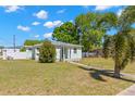 Cozy single-story house with a palm tree in the front yard and green grass at 501 61St Ne Ave, St Petersburg, FL 33703