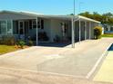 Inviting single-story home features a covered carport with a unique star design on the driveway at 5546 Benton St, Zephyrhills, FL 33542