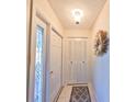 Inviting entryway featuring tile flooring, coat closet, and decorative wreath at 672 Allegheny Dr, Sun City Center, FL 33573