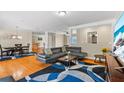 Spacious living room featuring an open floor plan, hardwood floors, and modern decor at 705 S West Shore Blvd, Tampa, FL 33609