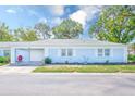 Charming single-story home with a light blue exterior, attached garage, and well-manicured lawn at 8066 Brentwood Rd # 8066, Seminole, FL 33777