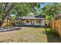 Charming single story home featuring a covered driveway, minimalist front yard landscaping, and a quaint front porch at 828 20Th S Ave, St Petersburg, FL 33705