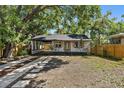 Charming single story home featuring a covered driveway, minimalist front yard landscaping, and a quaint front porch at 828 20Th S Ave, St Petersburg, FL 33705