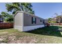 Charming single-story home with gray siding and white trim, nestled on a spacious lot with a well-kept lawn at 9420 Kiowa Dr, New Port Richey, FL 34654