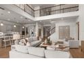 Spacious, light-filled living room open to kitchen with modern furnishings and soaring ceilings at 9825 Autumn Ridge Ave, Riverview, FL 33578