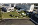Beautiful condominium complex featuring lush landscaping, pool, and serene waterfront views at 100 Bluff View Dr # 502C, Belleair Bluffs, FL 33770