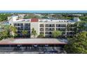 Aerial view of condo building with balconies, air conditioning units, and covered parking at 11485 Oakhurst Rd # A202, Largo, FL 33774