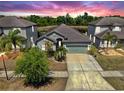 Charming single-story home featuring a well-manicured lawn, mature landscaping, and a two-car garage at 11872 Thicket Wood Dr, Riverview, FL 33579