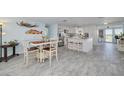 Bright dining area showcasing modern decor and an open layout connecting to the kitchen at 12821 5Th Isle, Hudson, FL 34667